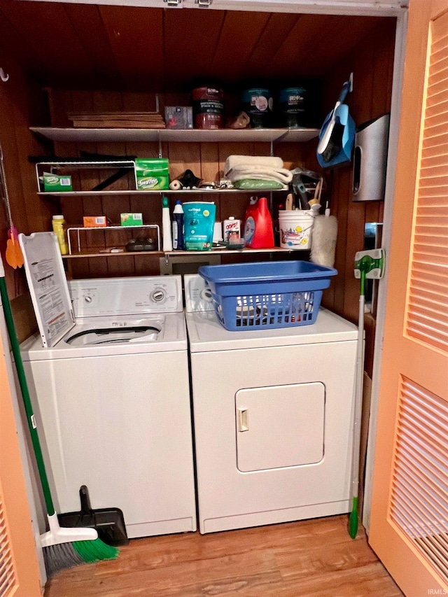 laundry room with light hardwood / wood-style floors and washer and dryer