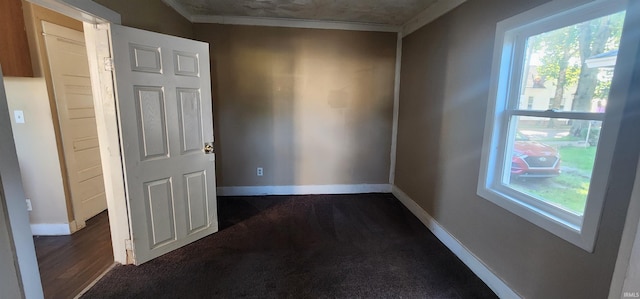 715 Osage St, Fort Wayne, IN 46808 - spare room with plenty of natural light, crown molding, baseboards, and dark carpet