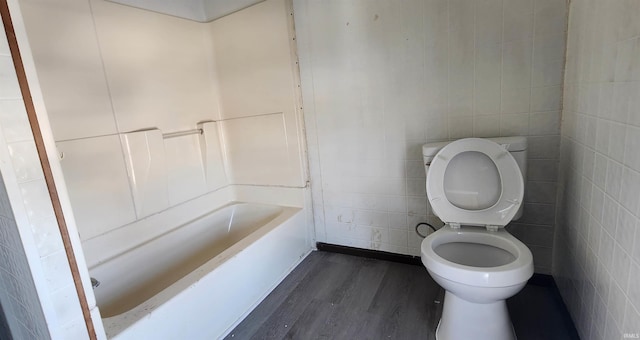 715 Osage St, Fort Wayne, IN 46808 - bathroom with wood finished floors, toilet, a bath, tile walls, and a shower