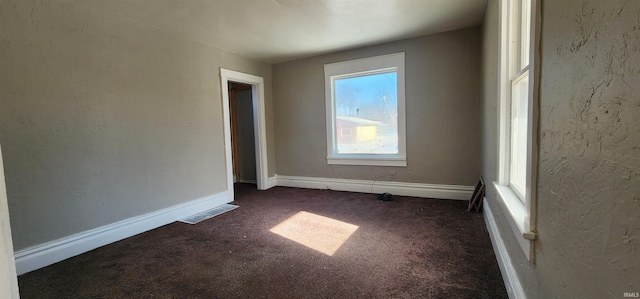 715 Osage St, Fort Wayne, IN 46808 - unfurnished room featuring dark colored carpet, a textured wall, and baseboards
