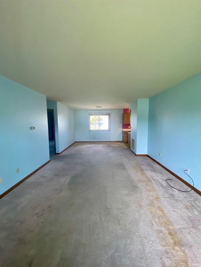 unfurnished living room featuring carpet flooring