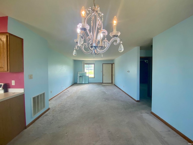 unfurnished dining area featuring carpet flooring and a notable chandelier