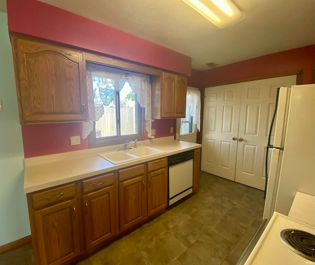 kitchen featuring sink, tile patterned floors, and white appliances