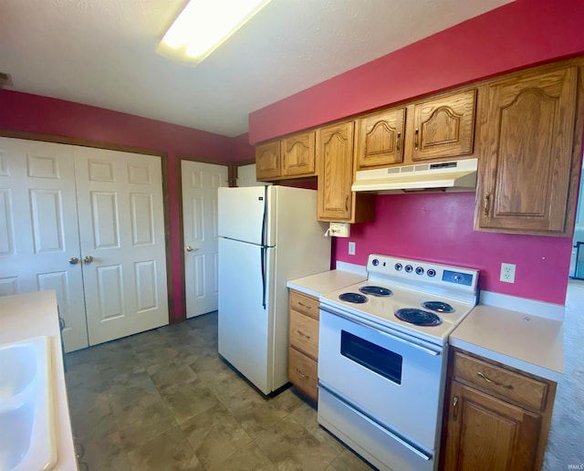 kitchen featuring sink, tile patterned floors, and white appliances