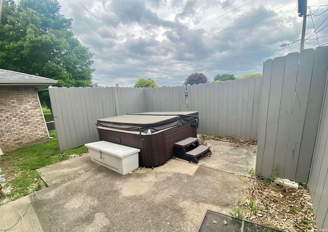 view of yard with a hot tub and a patio