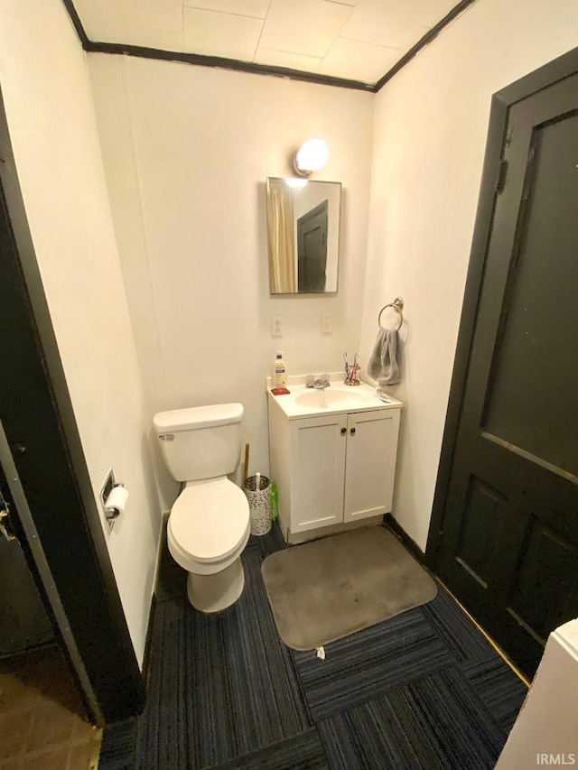 bathroom featuring vanity, ornamental molding, and toilet