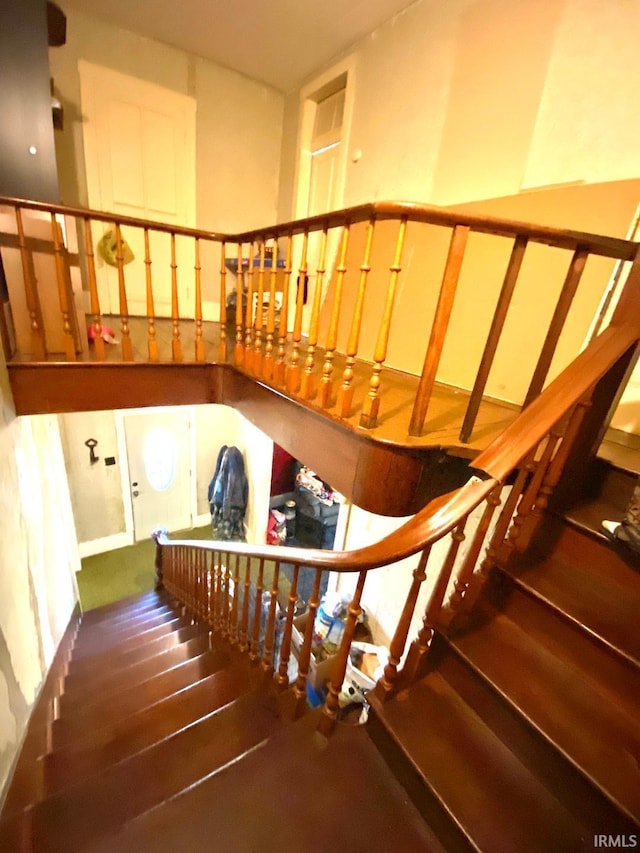 stairway with hardwood / wood-style flooring