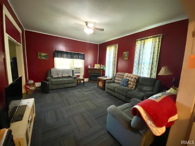 living room featuring ceiling fan and dark carpet