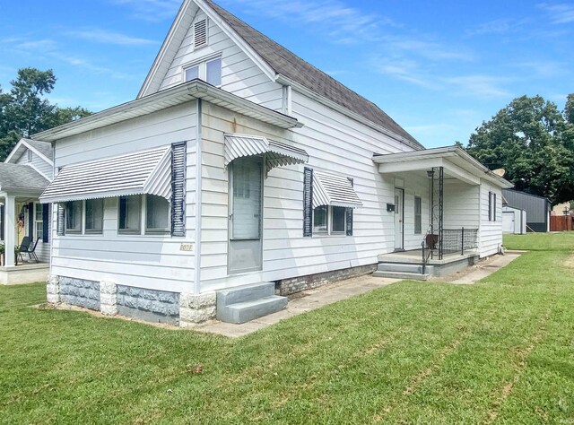 rear view of property with a yard