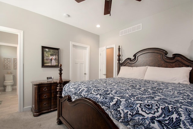 carpeted bedroom with ceiling fan and ensuite bathroom