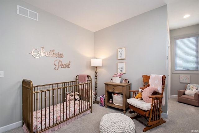 carpeted bedroom featuring a crib