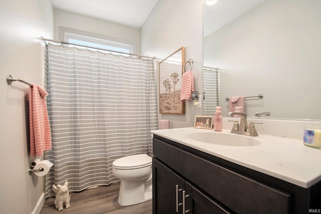 bathroom featuring toilet, lofted ceiling, hardwood / wood-style flooring, and vanity