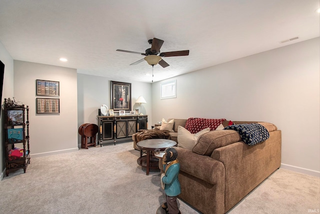 living room featuring ceiling fan and carpet