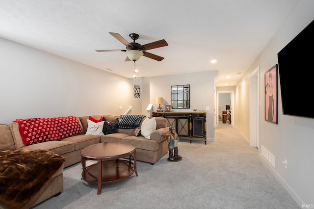 carpeted living room featuring ceiling fan