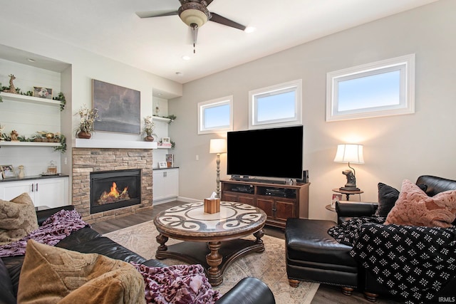 living room featuring hardwood / wood-style flooring, a fireplace, and ceiling fan