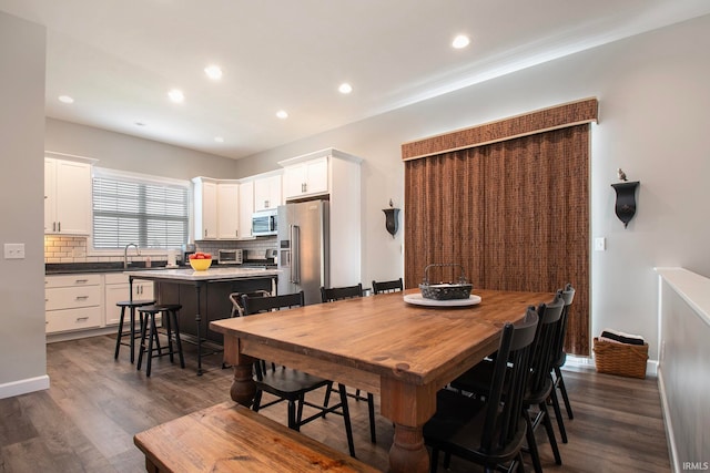 dining area featuring dark hardwood / wood-style flooring and sink