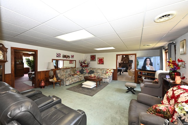 carpeted living room with a paneled ceiling