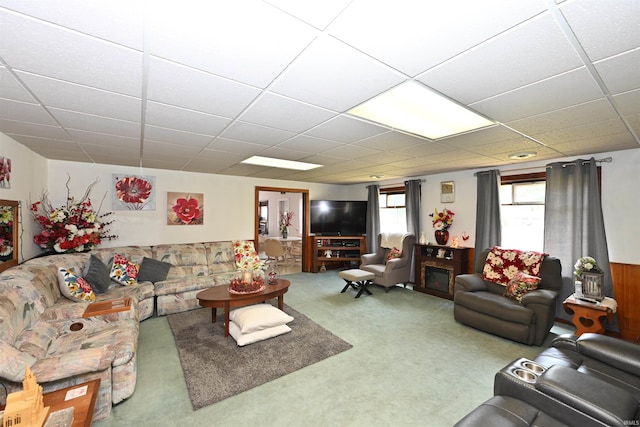 carpeted living room with a paneled ceiling