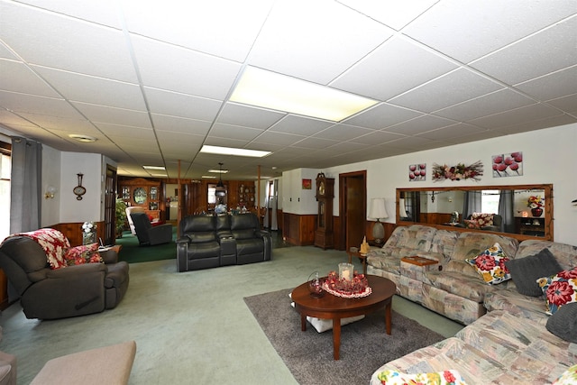 carpeted living room with a drop ceiling