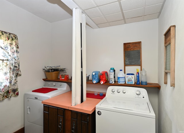 washroom with washing machine and dryer and cabinets