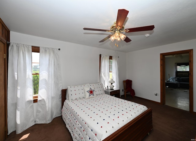 bedroom with dark colored carpet and ceiling fan