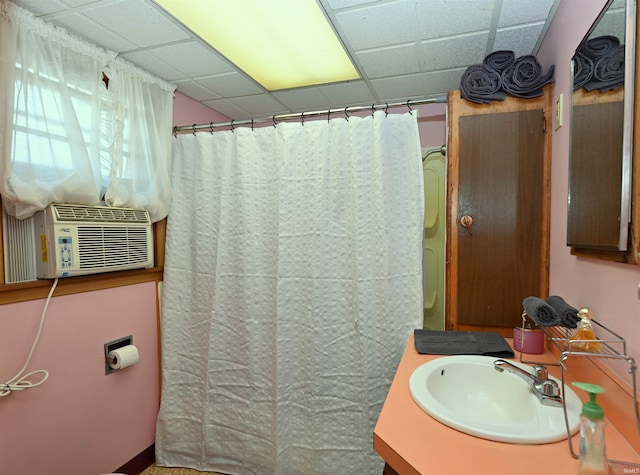 bathroom featuring cooling unit, vanity, and a drop ceiling