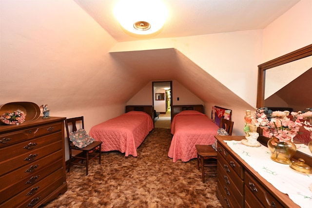 bedroom featuring vaulted ceiling and dark carpet