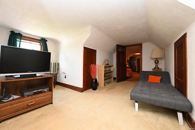 living area featuring vaulted ceiling and light colored carpet