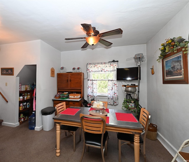 dining space with carpet flooring and ceiling fan