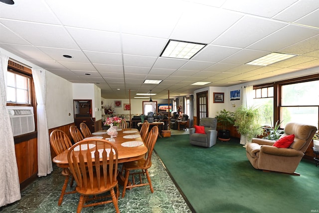 dining area with a wealth of natural light, a paneled ceiling, and cooling unit