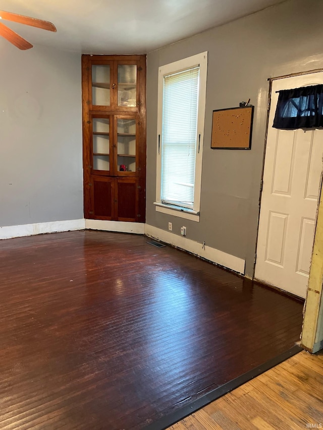 spare room featuring ceiling fan and hardwood / wood-style flooring