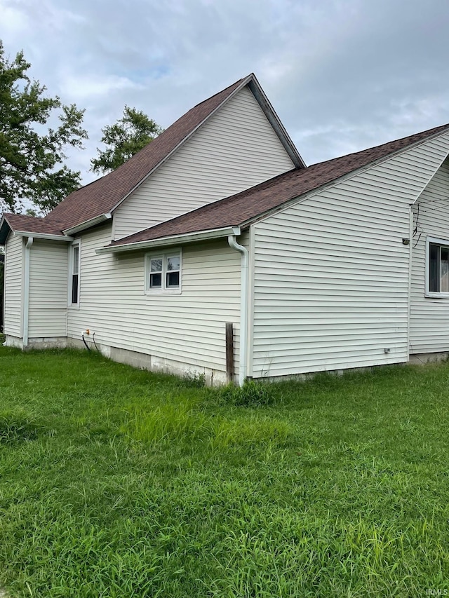 view of side of property with a lawn