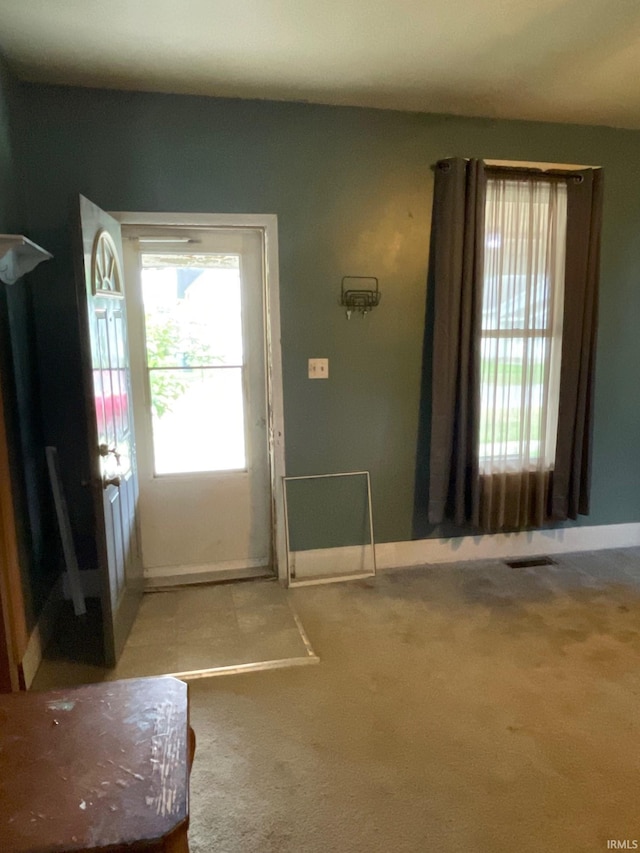 foyer entrance with carpet floors