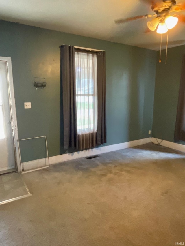 carpeted entrance foyer featuring ceiling fan