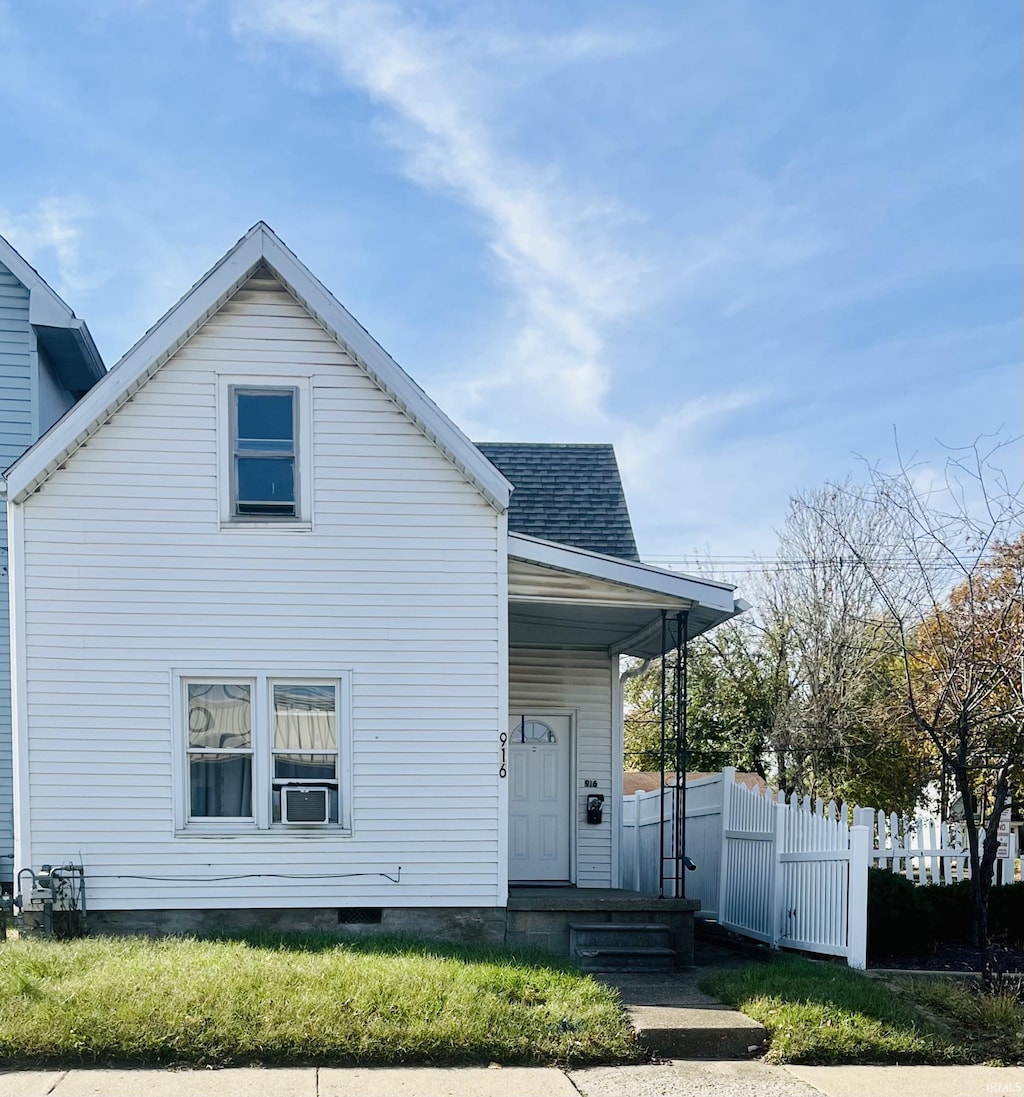 back of house with a lawn