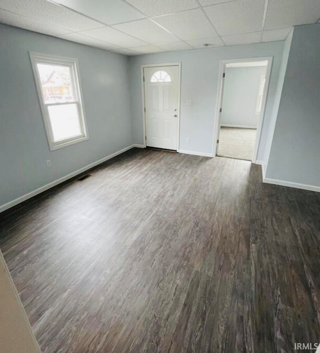 foyer entrance with a drop ceiling and dark hardwood / wood-style flooring