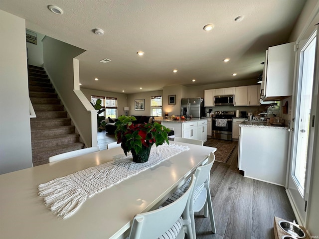 dining space featuring dark wood-type flooring