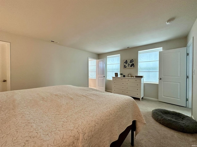 bedroom featuring light carpet