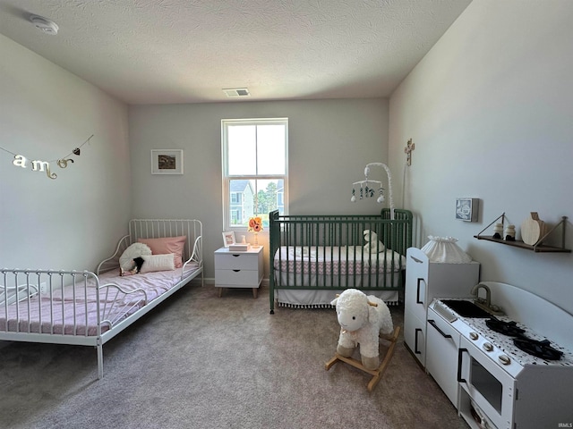 carpeted bedroom with a textured ceiling