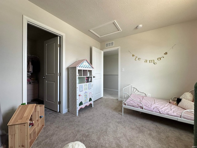 bedroom with a textured ceiling and carpet flooring