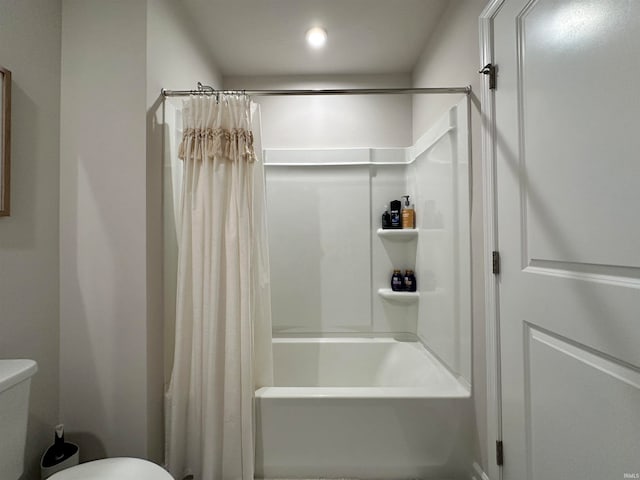 bathroom with toilet and shower / bath combo with shower curtain