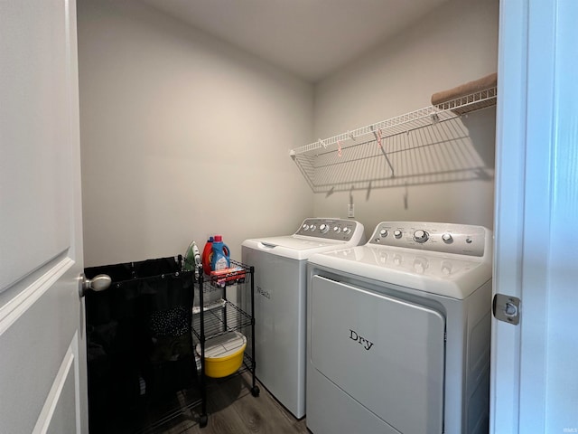 laundry room with hardwood / wood-style flooring and washer and dryer