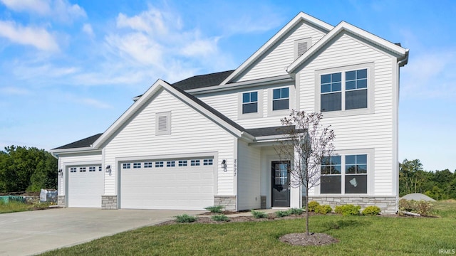 view of front of property featuring a garage and a front yard