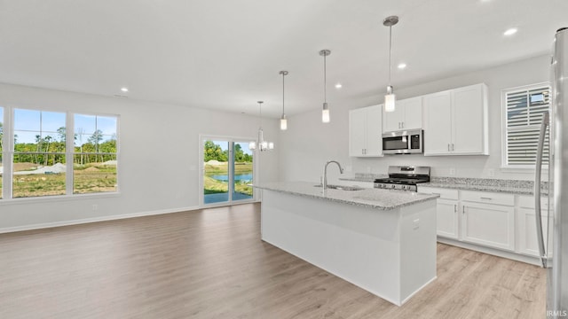 kitchen featuring sink, light hardwood / wood-style flooring, white cabinetry, and stainless steel appliances