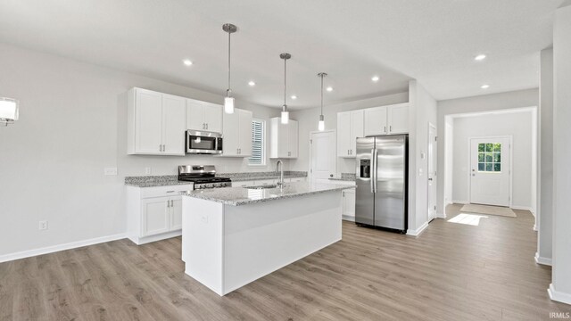 kitchen featuring white cabinets, light wood-type flooring, and appliances with stainless steel finishes