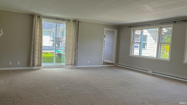 unfurnished room featuring crown molding, a baseboard heating unit, and carpet floors