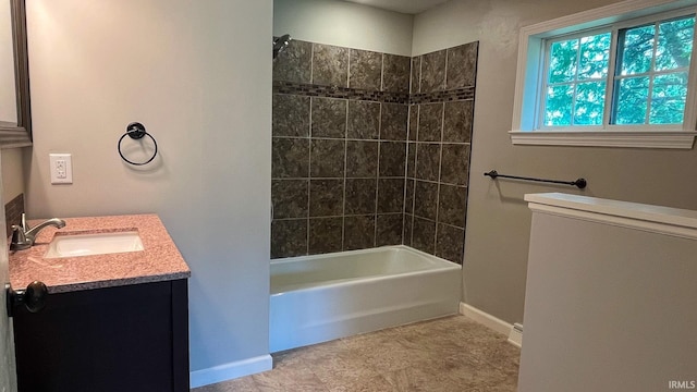 bathroom with vanity and tiled shower / bath combo