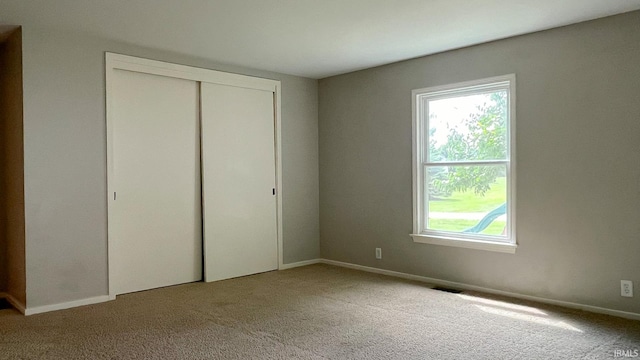 unfurnished bedroom featuring light carpet