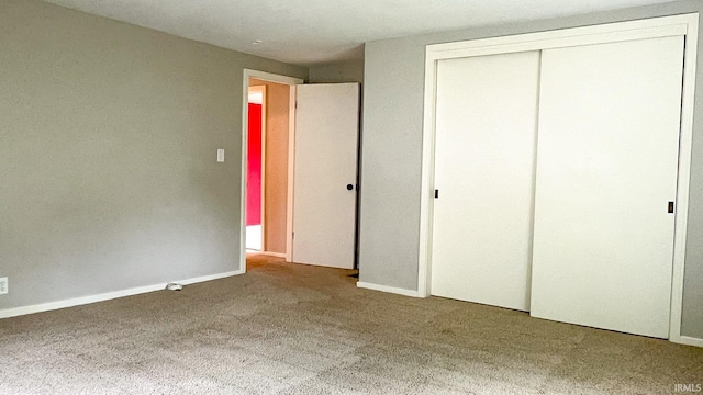 unfurnished bedroom with a closet and carpet floors