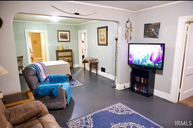 living room with crown molding and concrete floors